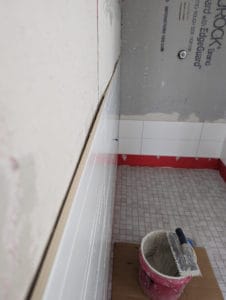 Very difficult to get a flat tile install with wavy walls like this