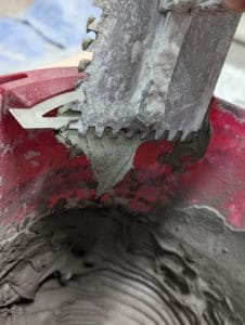 Scraping clean trowel with Bucket Scrape by Bucky Tools