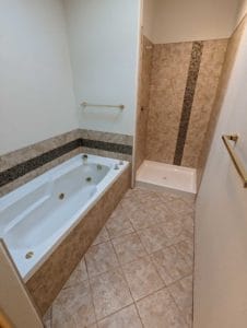 Master bathroom floor, tub, and shower finished