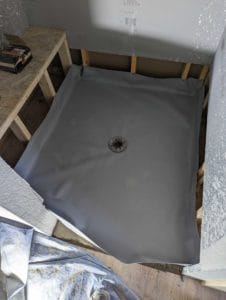 Shower pan liner installed above cement pre-pan