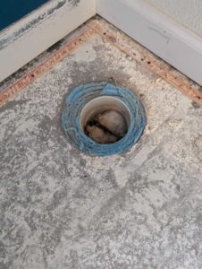 Old toilet drain found in floor will need to be filled