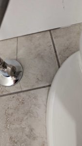 Broken tile at toilet supply line