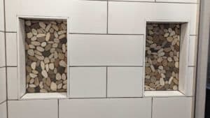 Master shower niche pebbles grouted