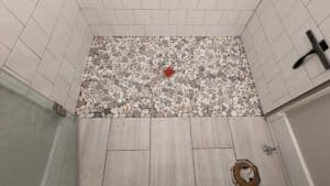 Pebbles installed in shower floor