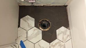 Fun hexagon cuts around guest toilet flange