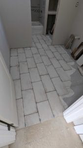 Installed most of the upstairs bath floor - an intentionally alternating offset pattern