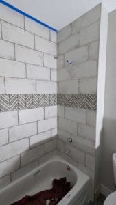 Basement tub surround plumbing wall grouted