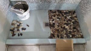 Basement shower floor pebbles in progress