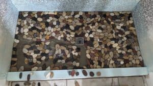 Basement shower floor pebbles in progress2