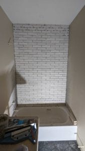 Installed back wall on basement tub surround