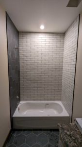 Basement tub surround grouted and finished