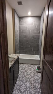 Upstairs tub surround and floor grouted and finished