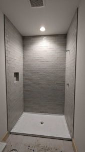 Guest shower grouted, caulked, and finished