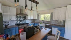 Some tiles to be removed/replaced and tiles added above/in window in this kitchen backsplash