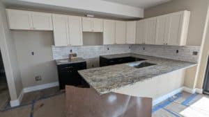 Basement kitchen backsplash nearly completely installed