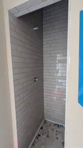 Plumbing walls grouted in upper bath shower