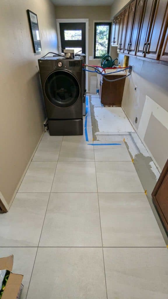 Washer and dryer moved and area left to be tiled