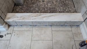 Curb installed and tile on outside, top, inside