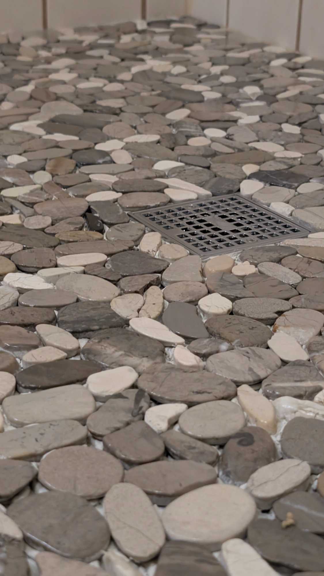 Closeup of pebble shower floor