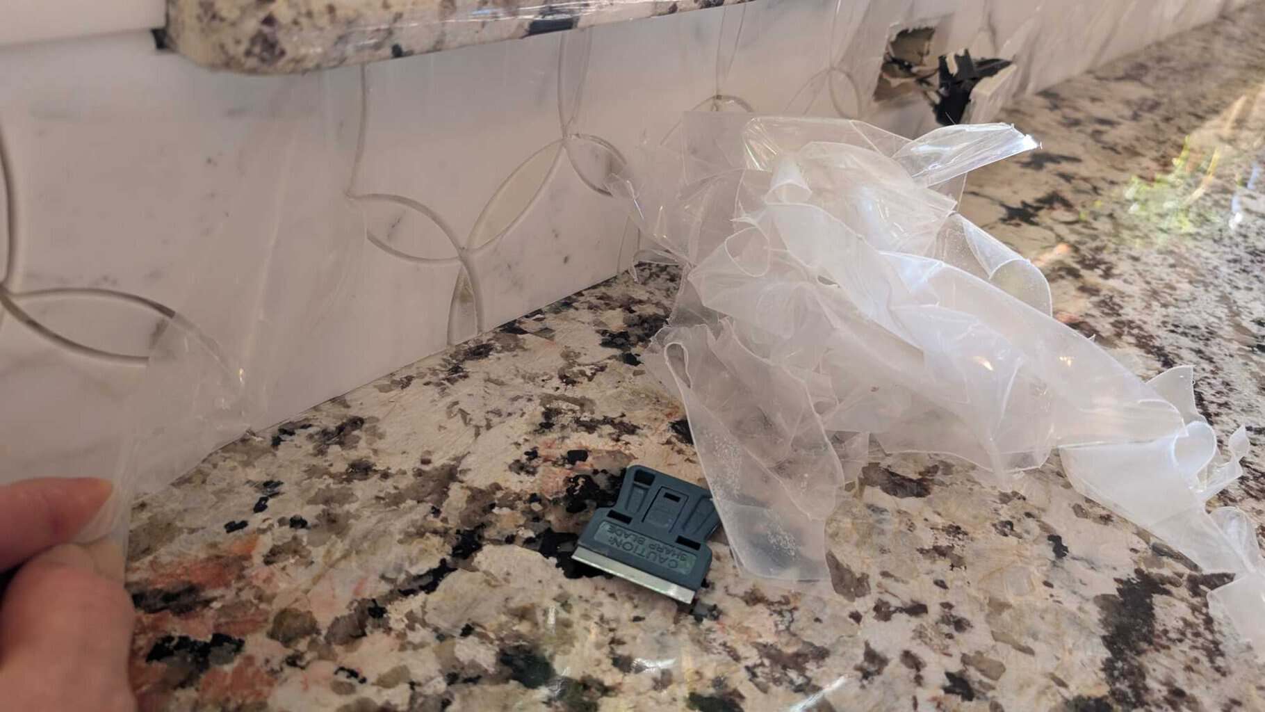 Peeling plastic from the front of all tiles Peeling plastic from the front of all tiles