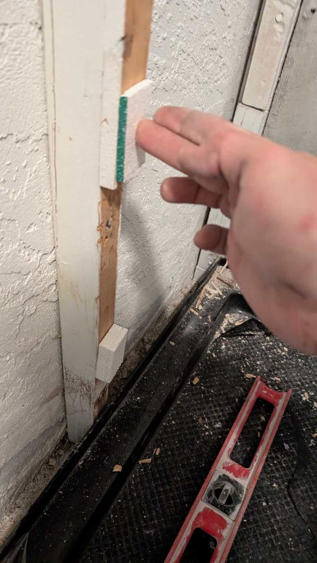 Putting foam shims to help get the walls flatter