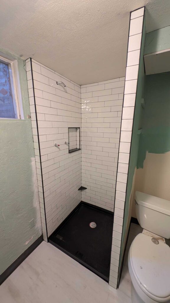 Basement shower grouted and finished