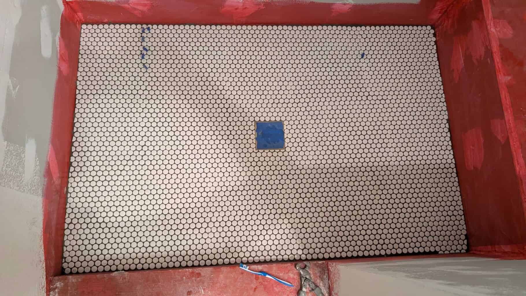 Penny tile installed on shower floor