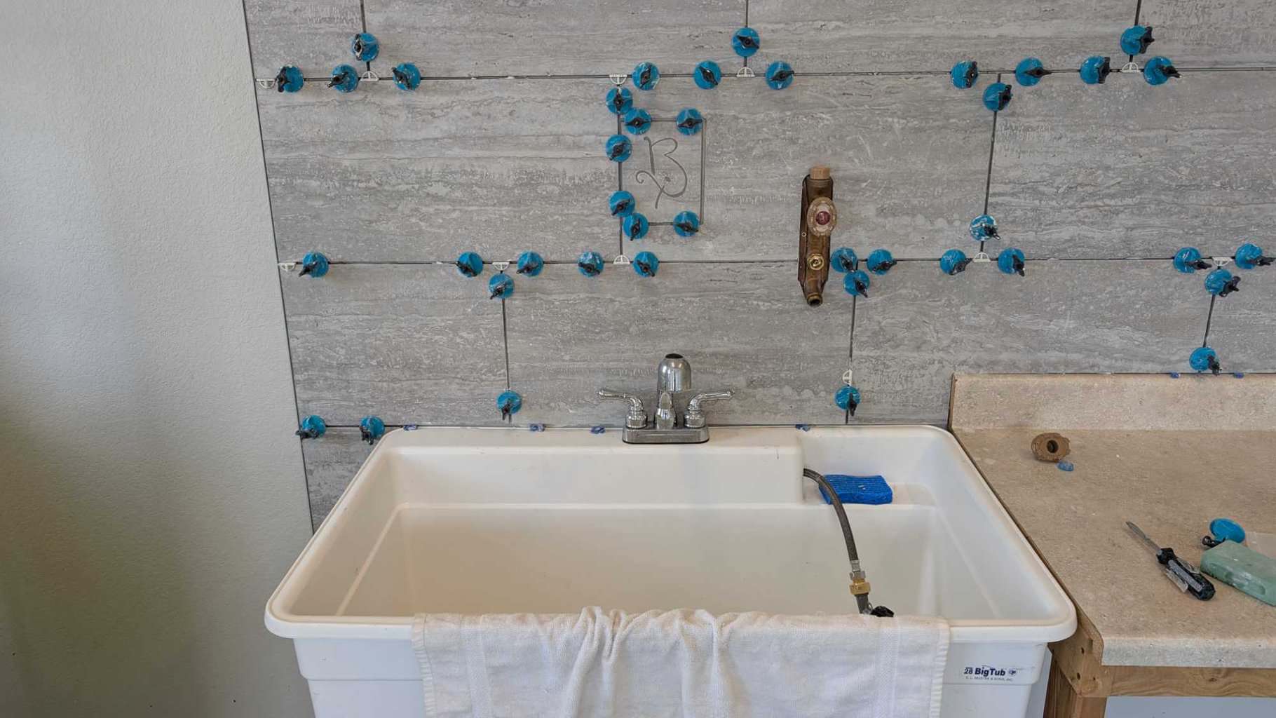 Logo accent tile added above sink