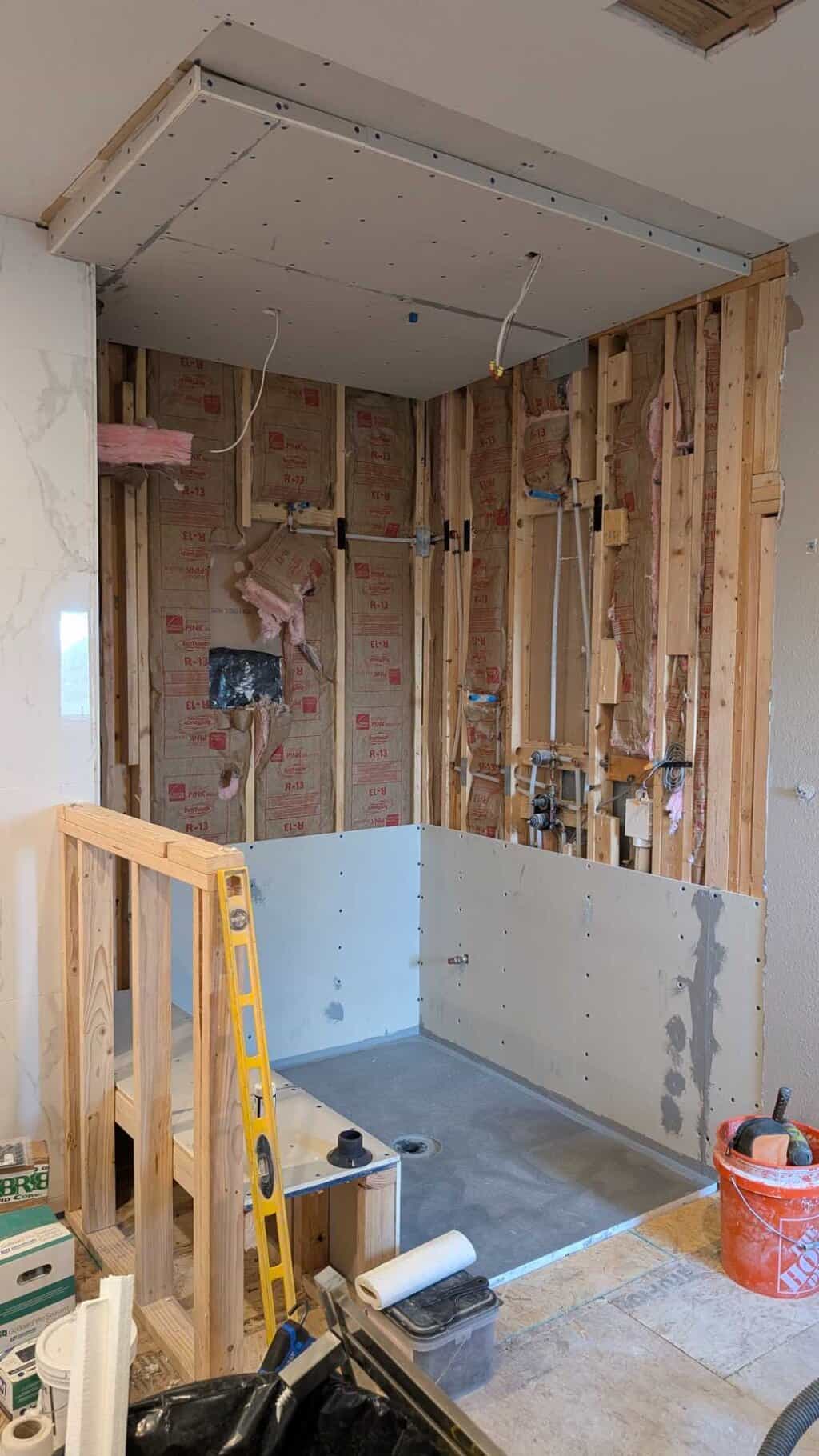 Shower pan installed and ceiling and some walls underlaid
