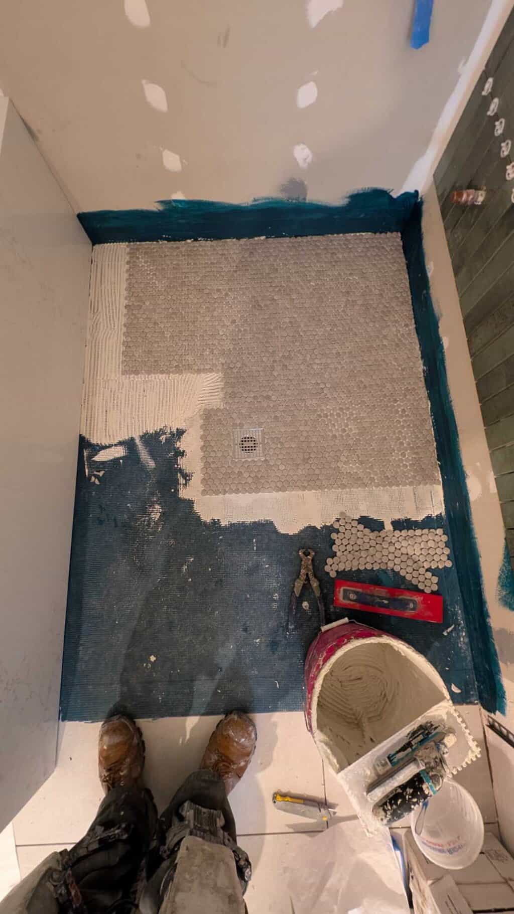 Installing the penny tiles in the primary shower floor