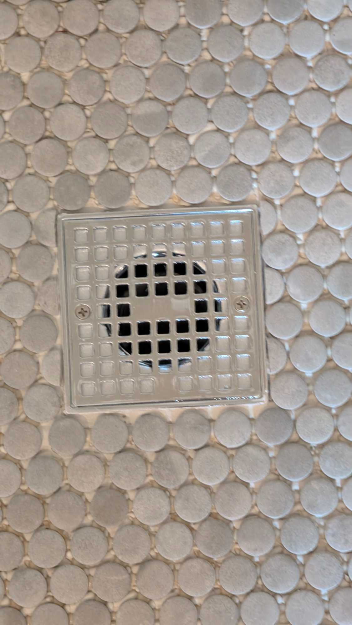 Closeup of drain and pennies