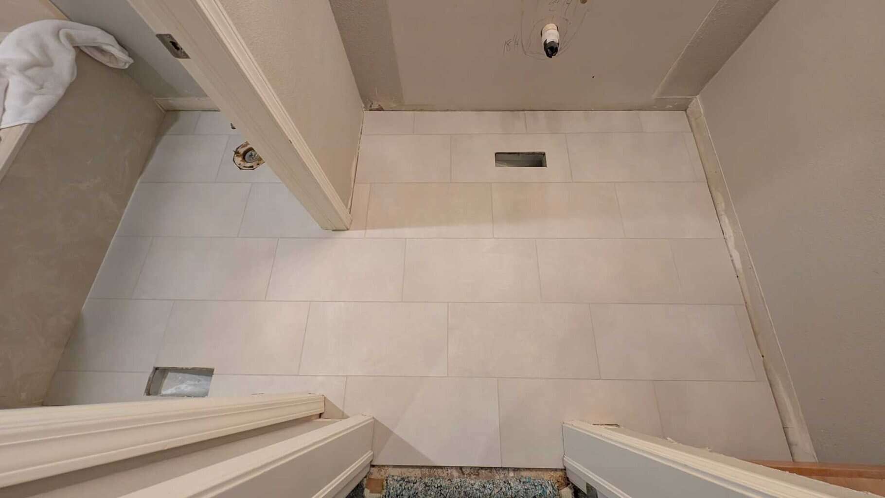 Secondary bath floor is grouted and finished