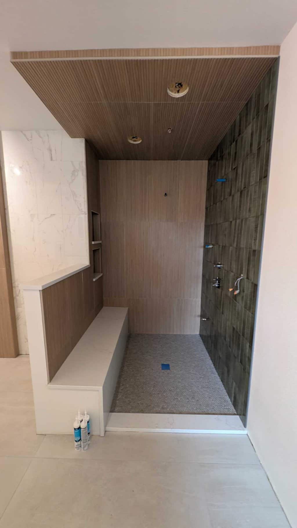 Primary bathroom shower is grouted and finished