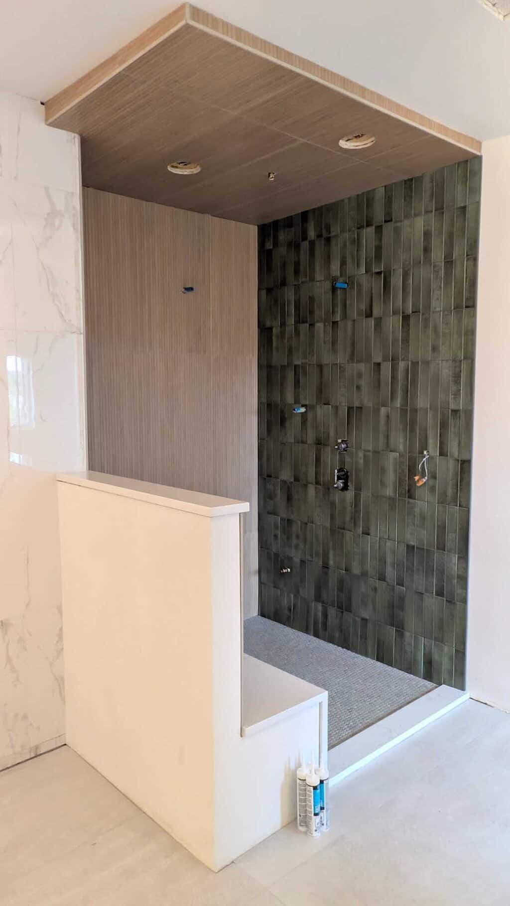 Primary bathroom shower is grouted and finished2