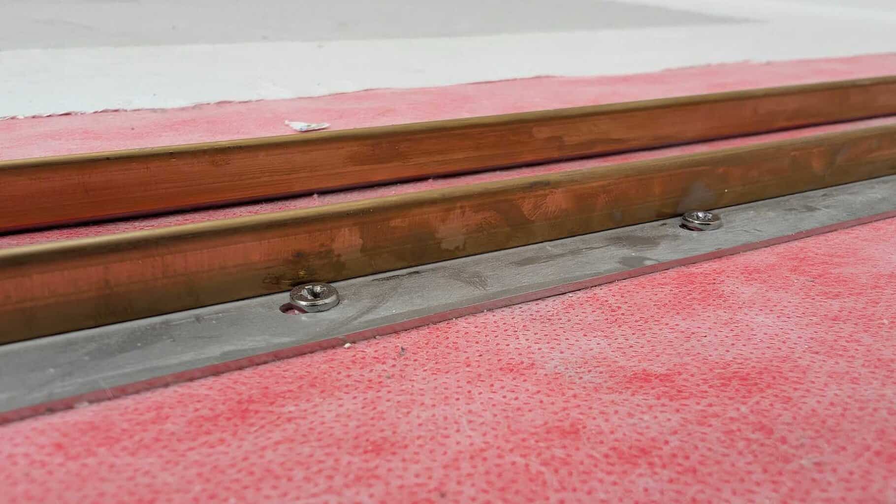 Channels set on drain in hall bath