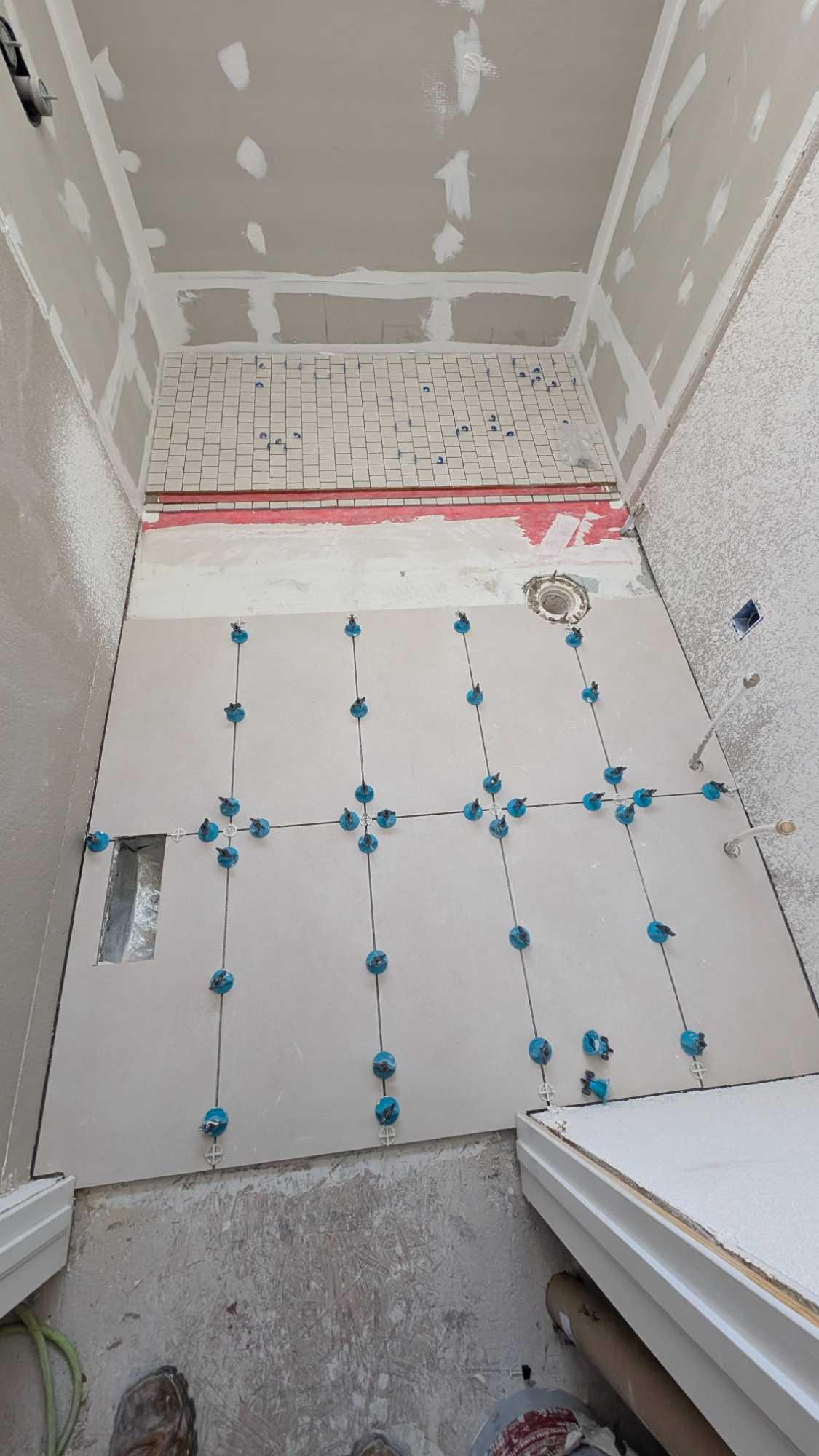 Most of shower floor set and most of bath floor set