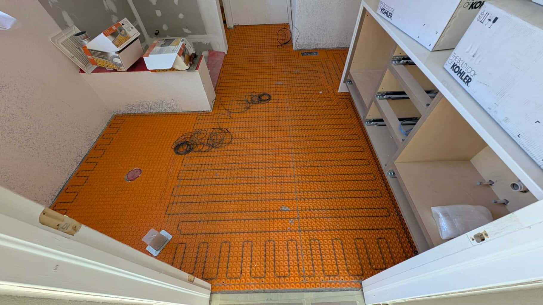 Warm wire installed in primary bath floor - but too much excess