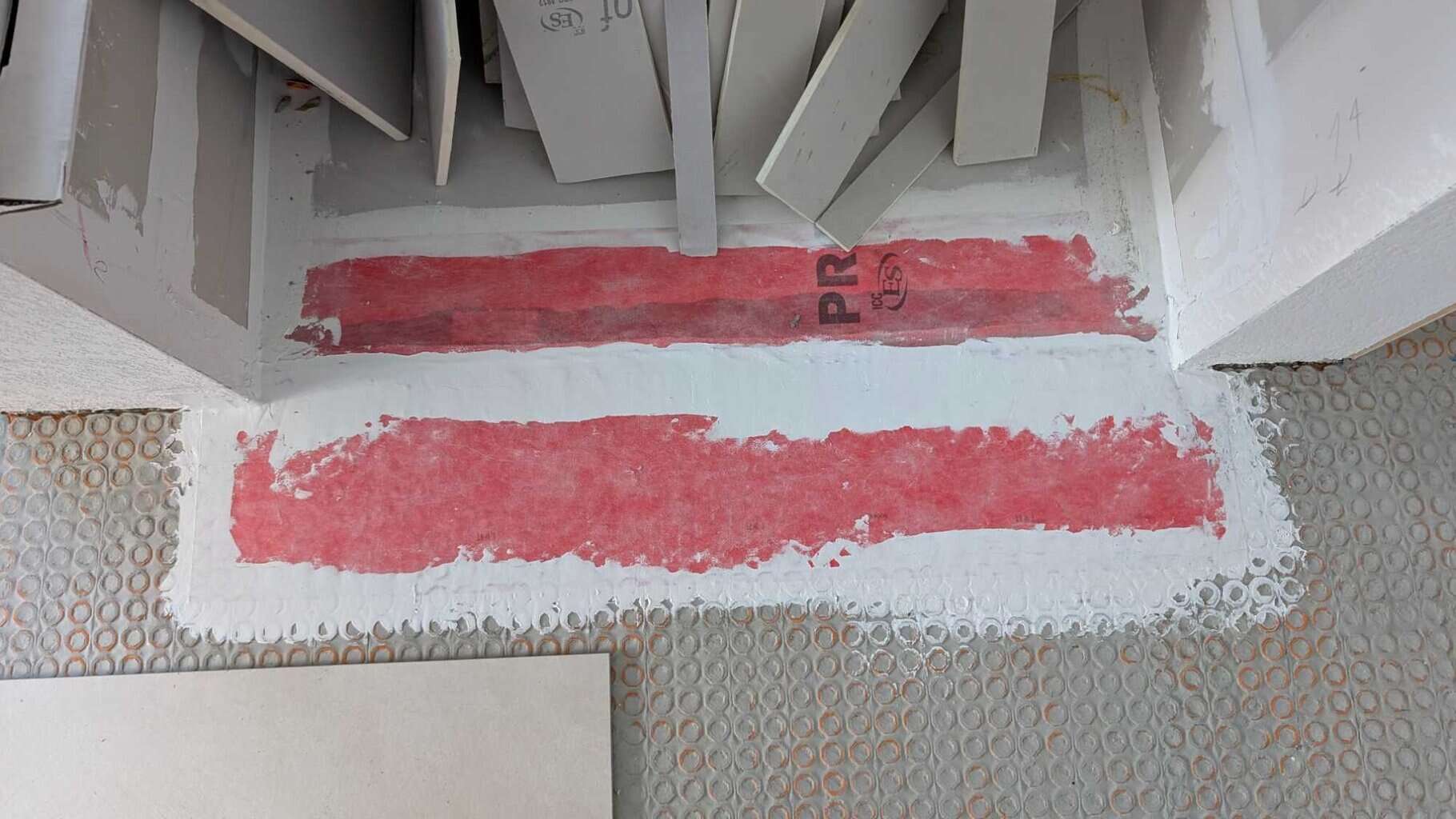 Sealed shower pan membrane down to underlayment