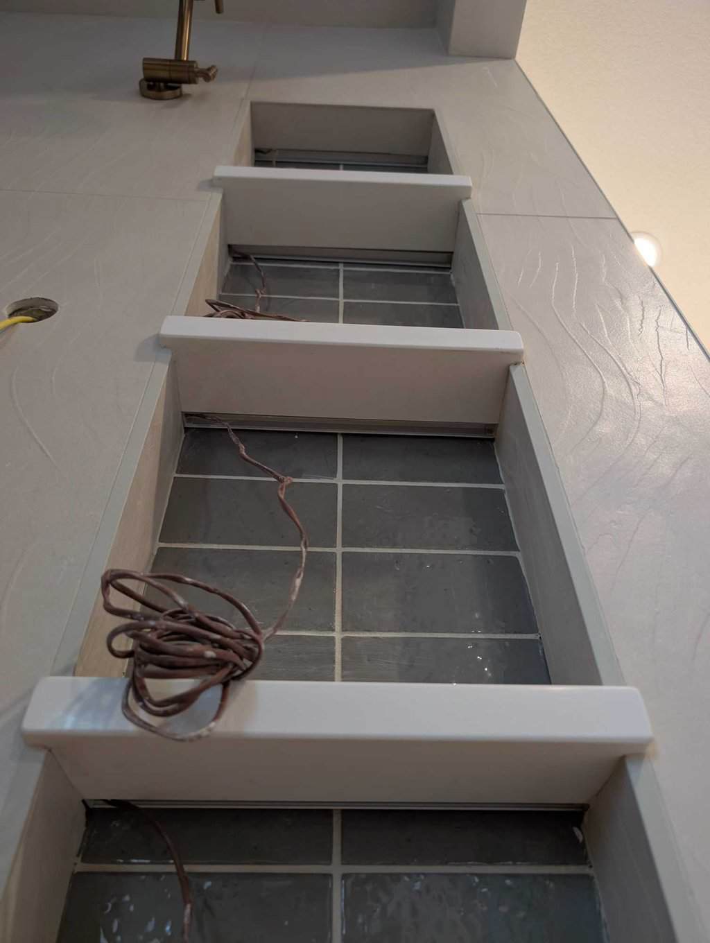 Niche shelf light rails installed