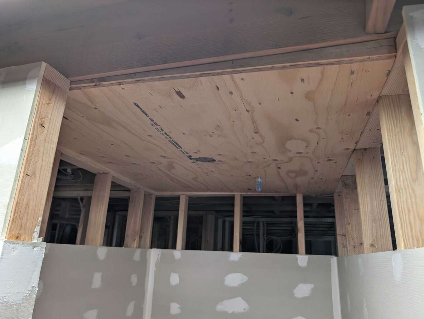 Ceiling plywood installed, but header still missing