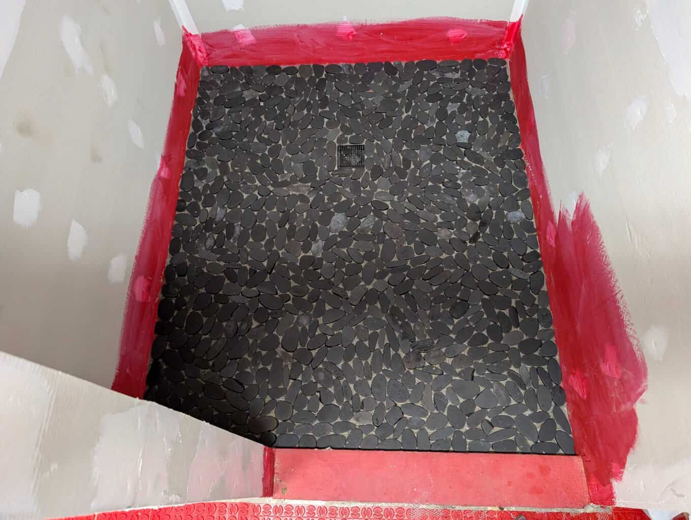 Primary shower floor pebbles installed