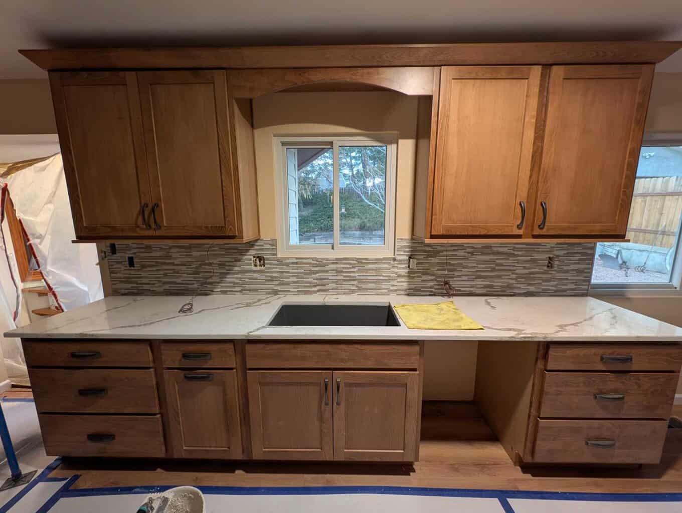 Glass strip mosaic tiles installed on part of backsplash