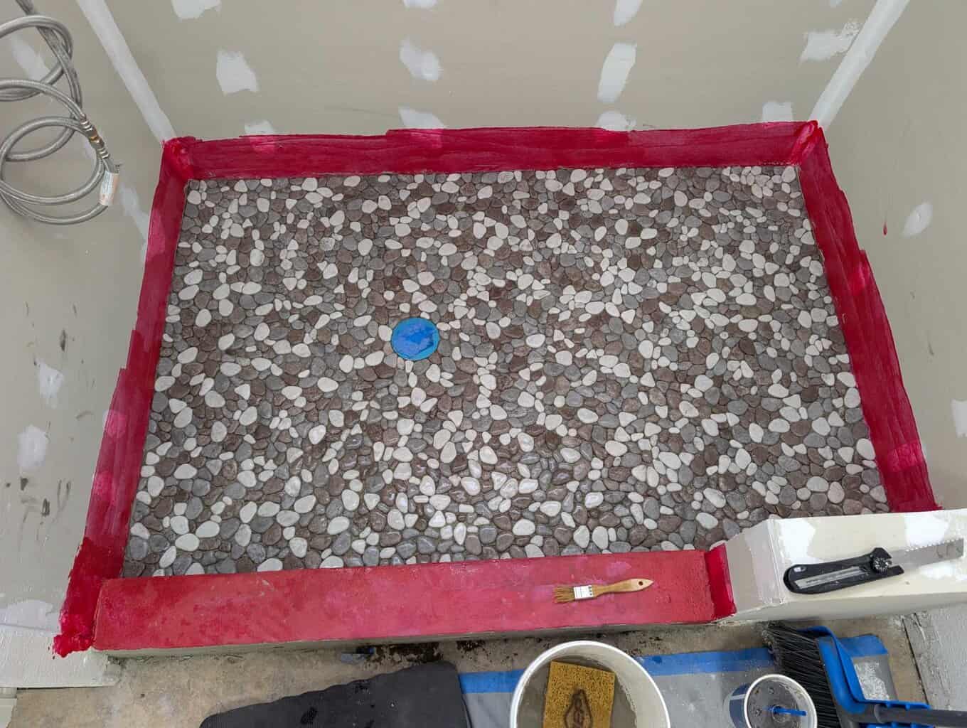Pebbles installed on shower floor