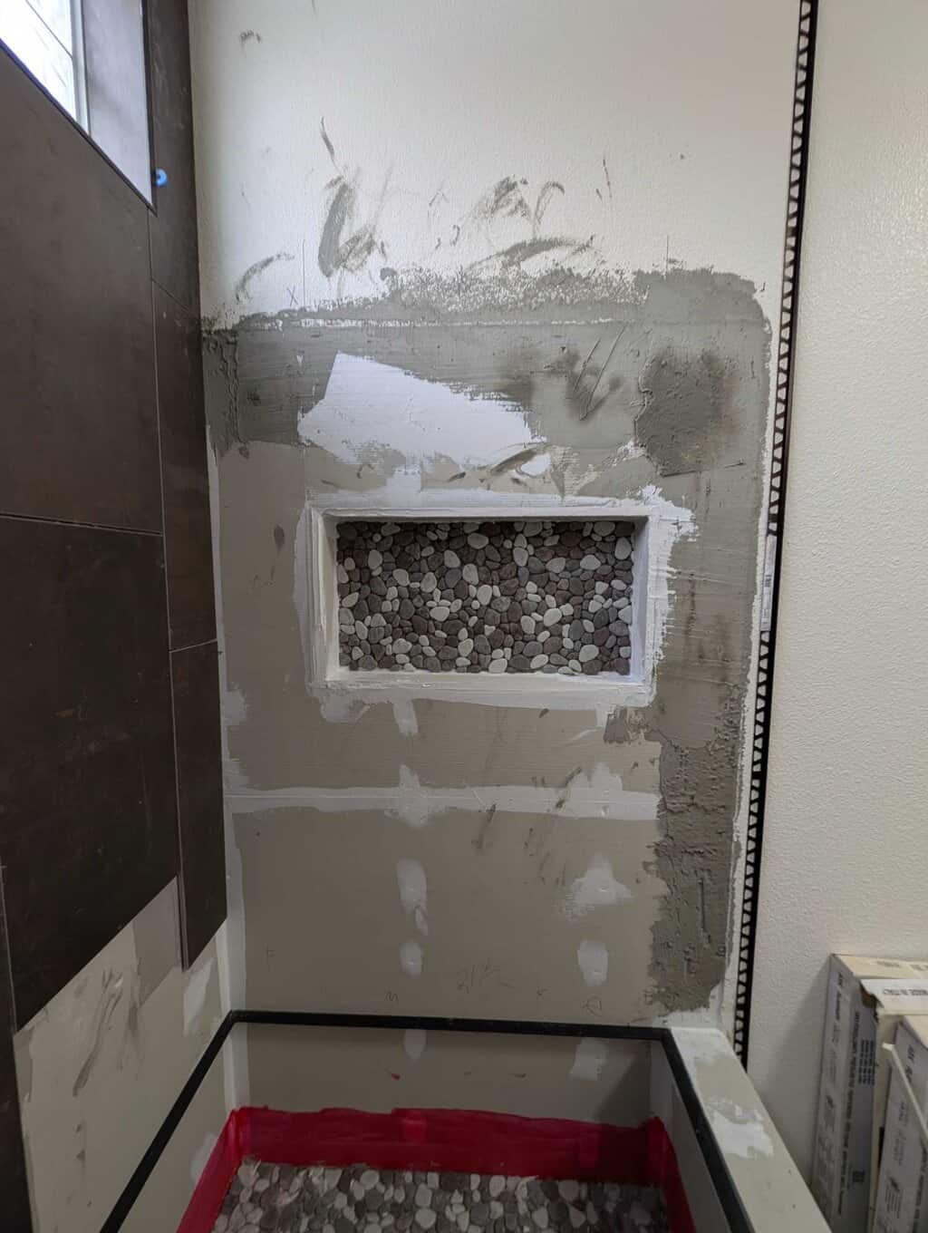 Accent tile installed in back of niche