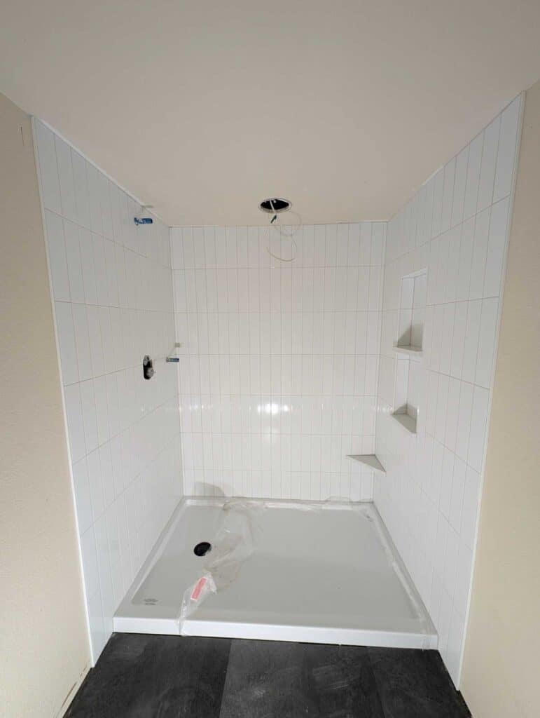 Basement shower surround grouted and finished