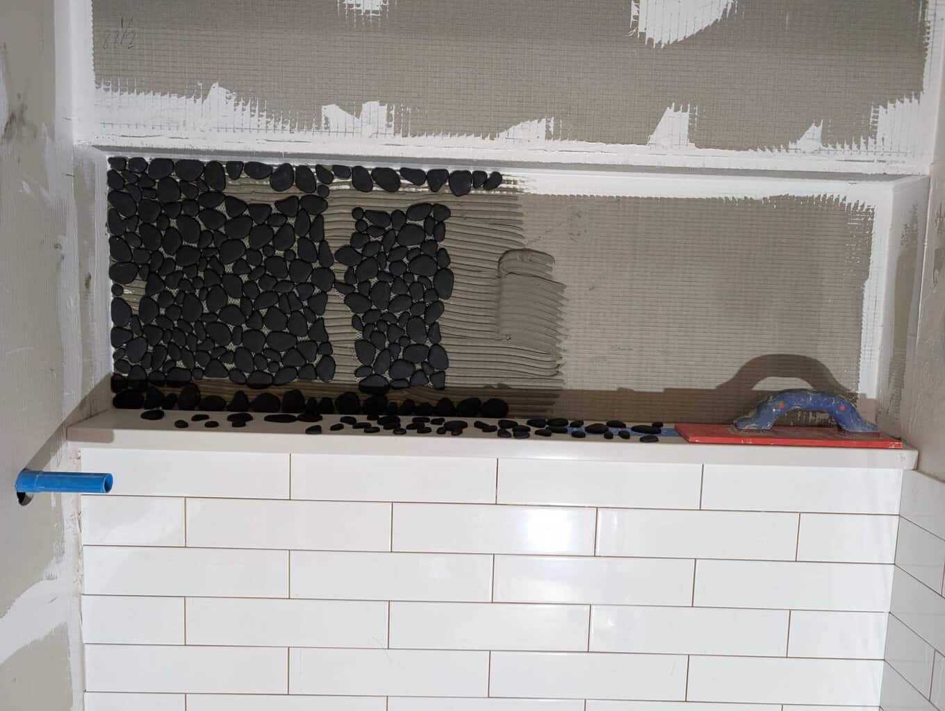 Installing pebbles in niche