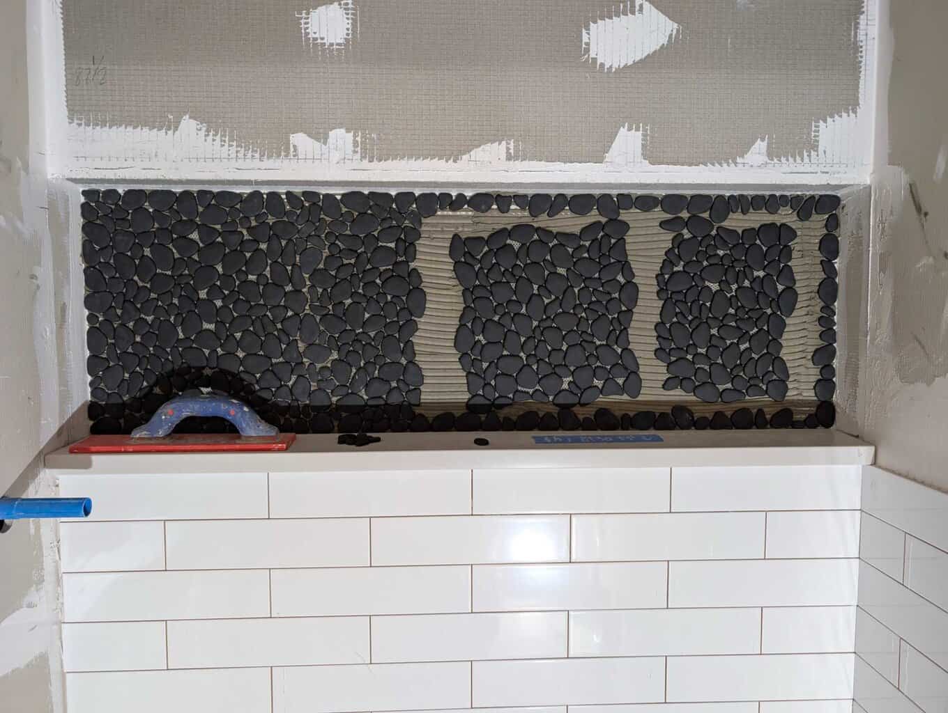 Installing pebbles in niche