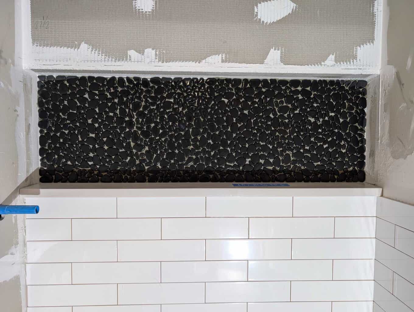 Pebbles installed in niche