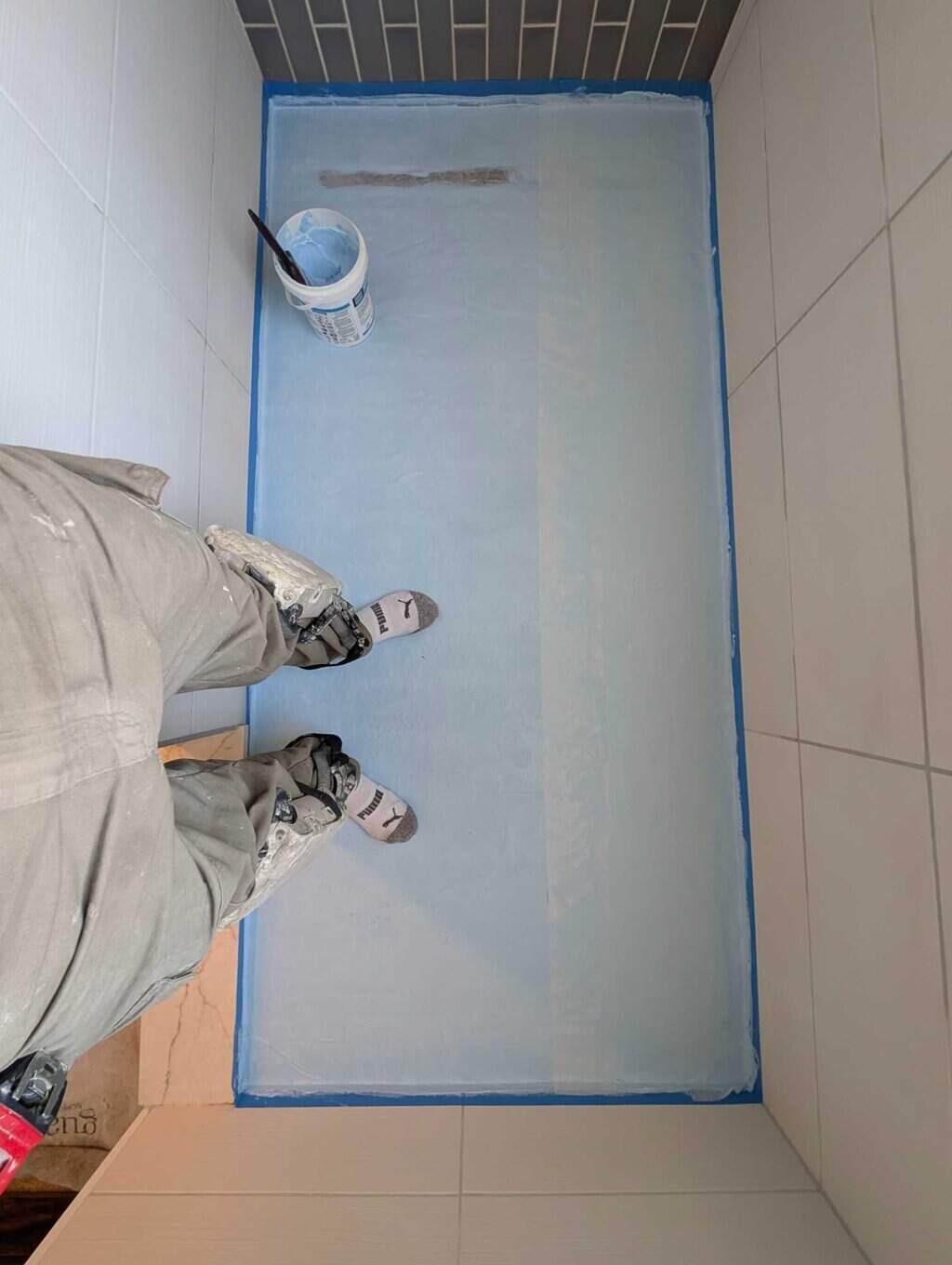 Installing 2nd coat of waterproofing with reinforcing fabric