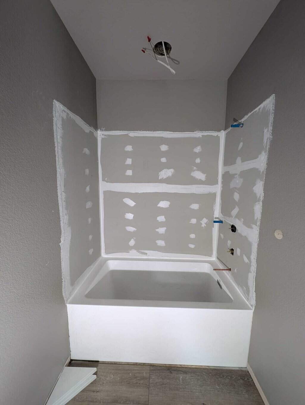 Walls installed and sealed on tub surround